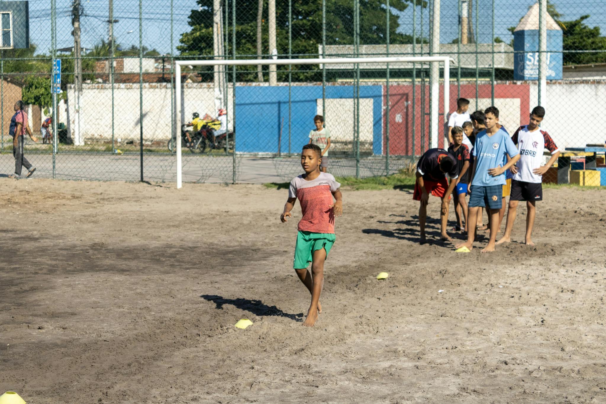 Boys practicing soccer on a sunny day, showcasing teamwork and athletic skills.